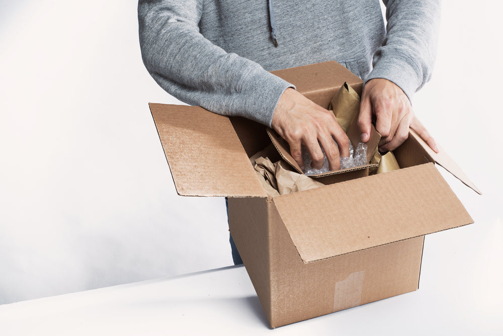 young man preparing a package for fulfillment